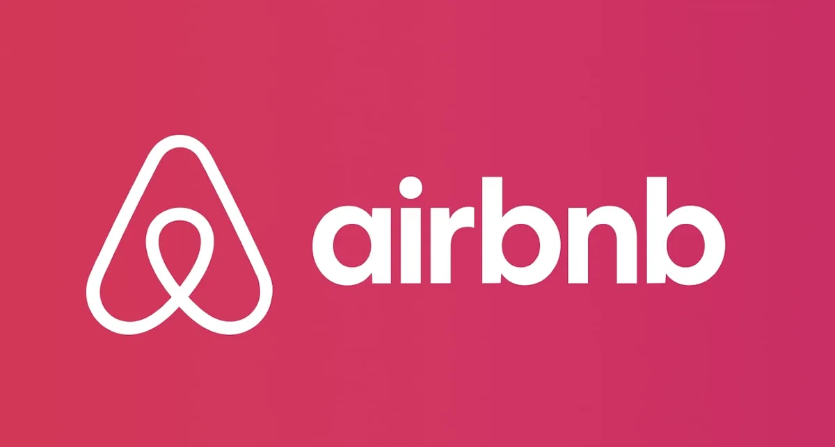 粉色背景上的 Airbnb 白色标志